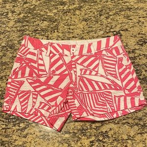 Lilly Pulitzer Callahan Shorts in a size 0. They’re white with pink detailing.